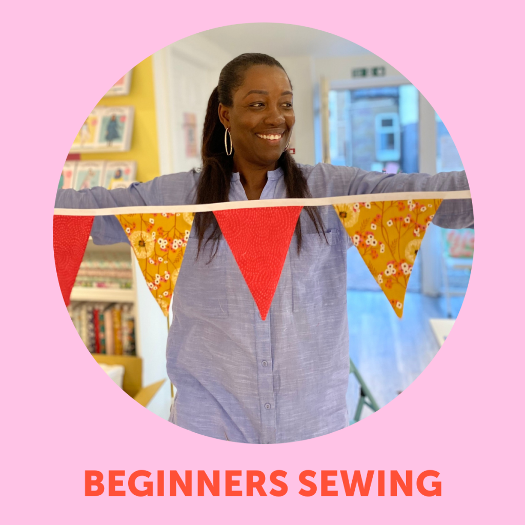 image of customerBeginners sewing classes in dundee. Image of person holding a string of bunting.